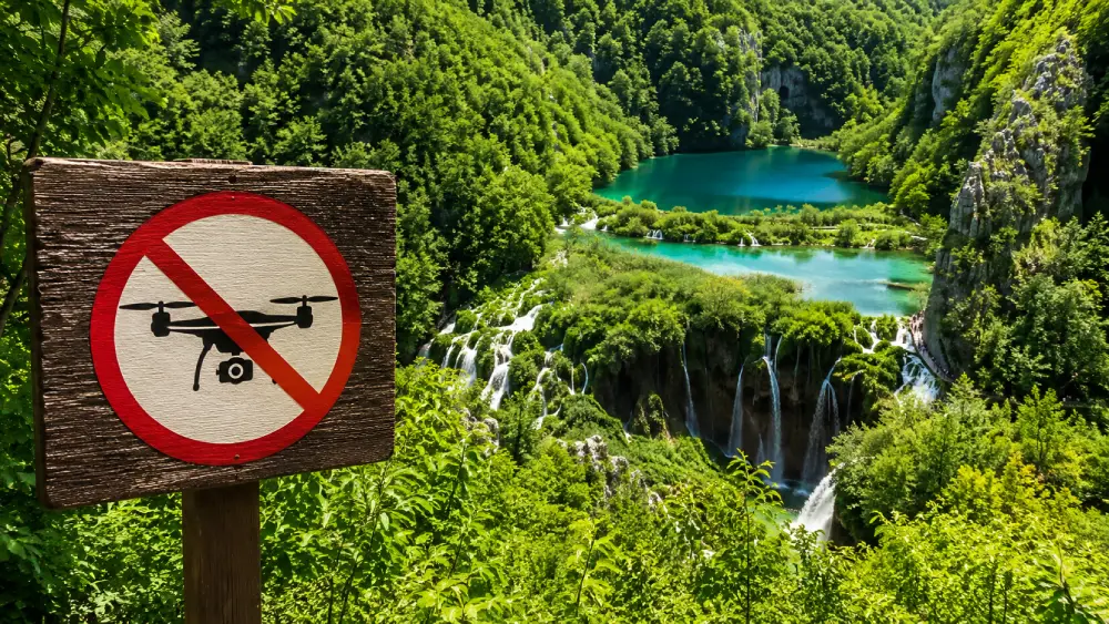 No drone flying sign in front of the beautiful waterfalls at Plitvice Lakes National Park.