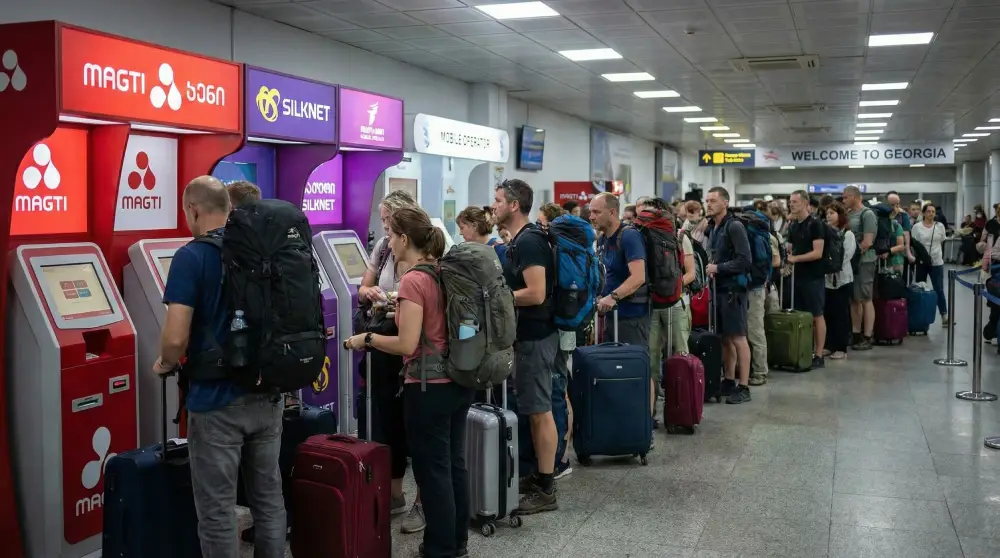 ravelers waiting in long queues at mobile operator kiosks at Tbilisi International Airport to buy local SIM cards.