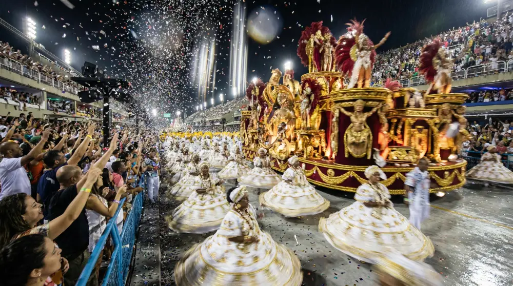 Dancers and floats performing at the Sambadrome parade in Rio de Janeiro, showcasing elaborate costumes.