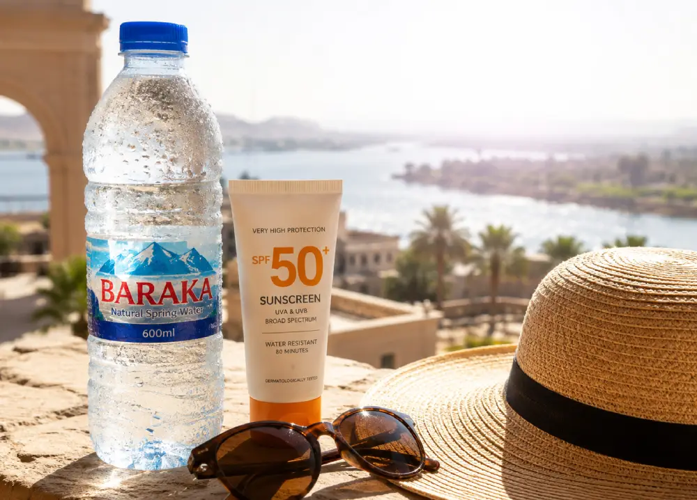 Essential items for health in Egypt's hot climate include cold plastic bottled water with water droplets on it, sunscreen, and a sun hat.