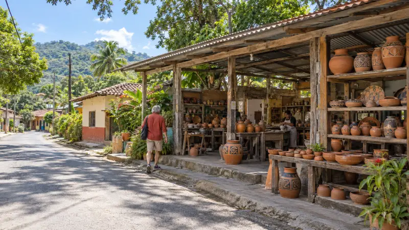 Illustrative Guaitil village scene with a visitor approaching an open-front pottery workshop.